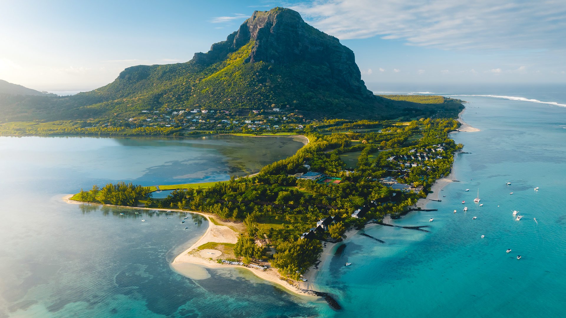 Aerial photograph of Paradis Beachcomber, turquoise lagoons and Le Morne mountain in Mauritius